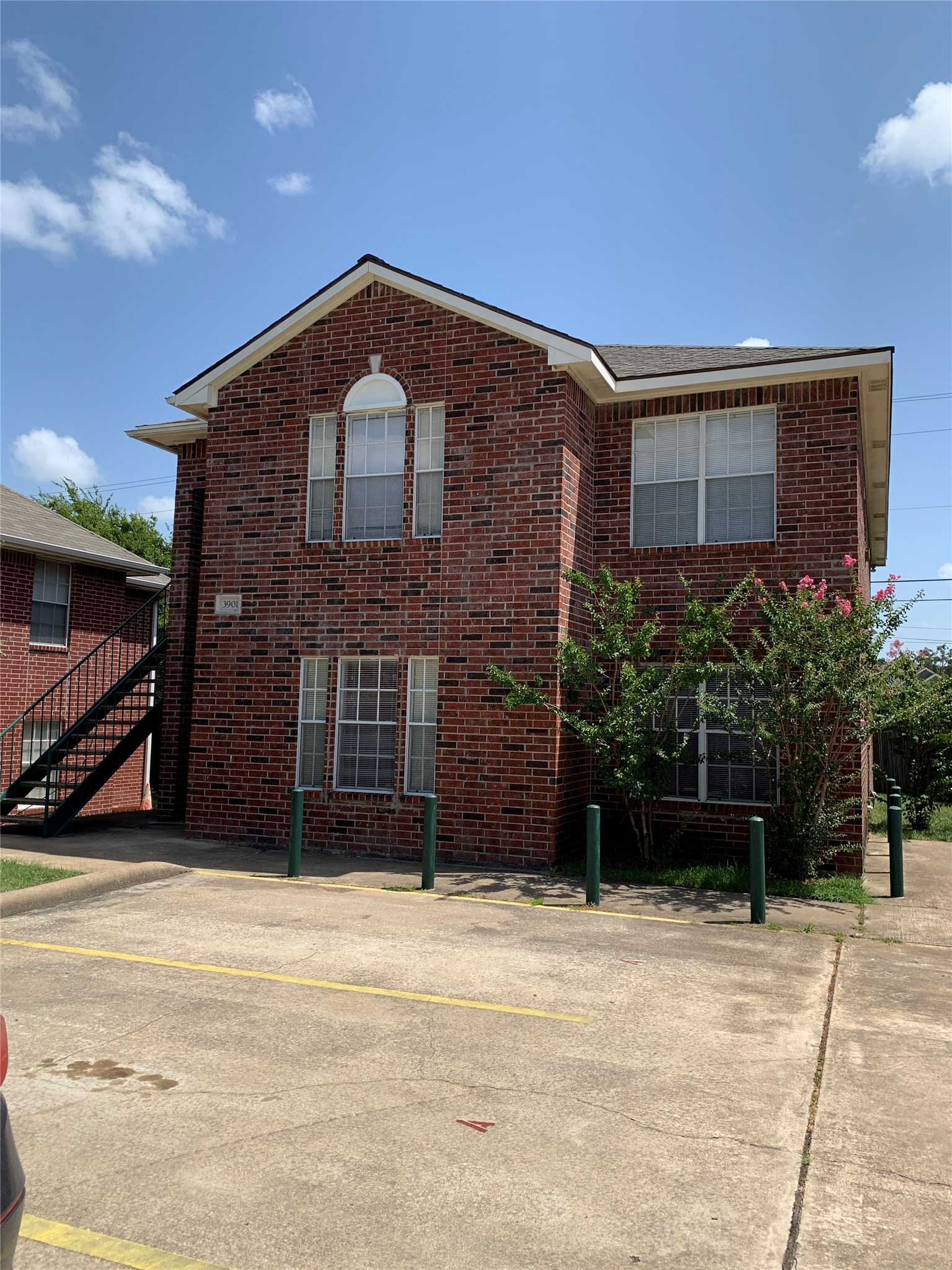 3901 College Main Street, Unit B Bryan, TX 77801 - Photo 4 of 25 a front view of a house with a yard