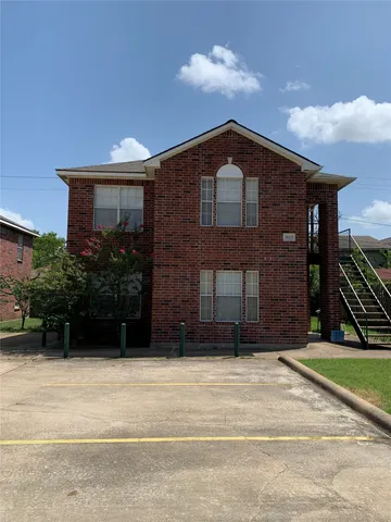 a car parked in front of a brick house