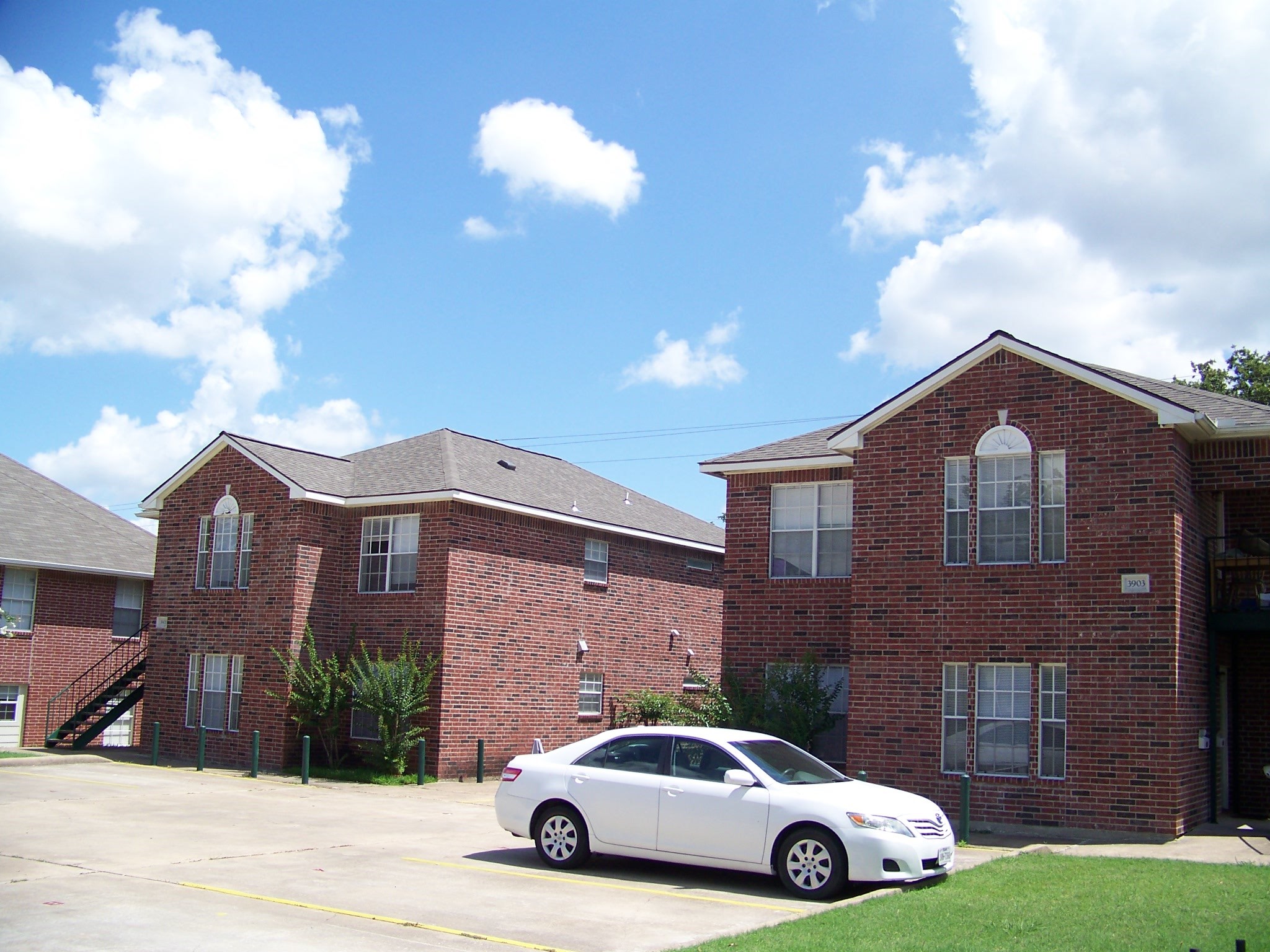 3901 College Main Street, Unit B Bryan, TX 77801 - Photo 6 of 25 a car parked in front of a brick house