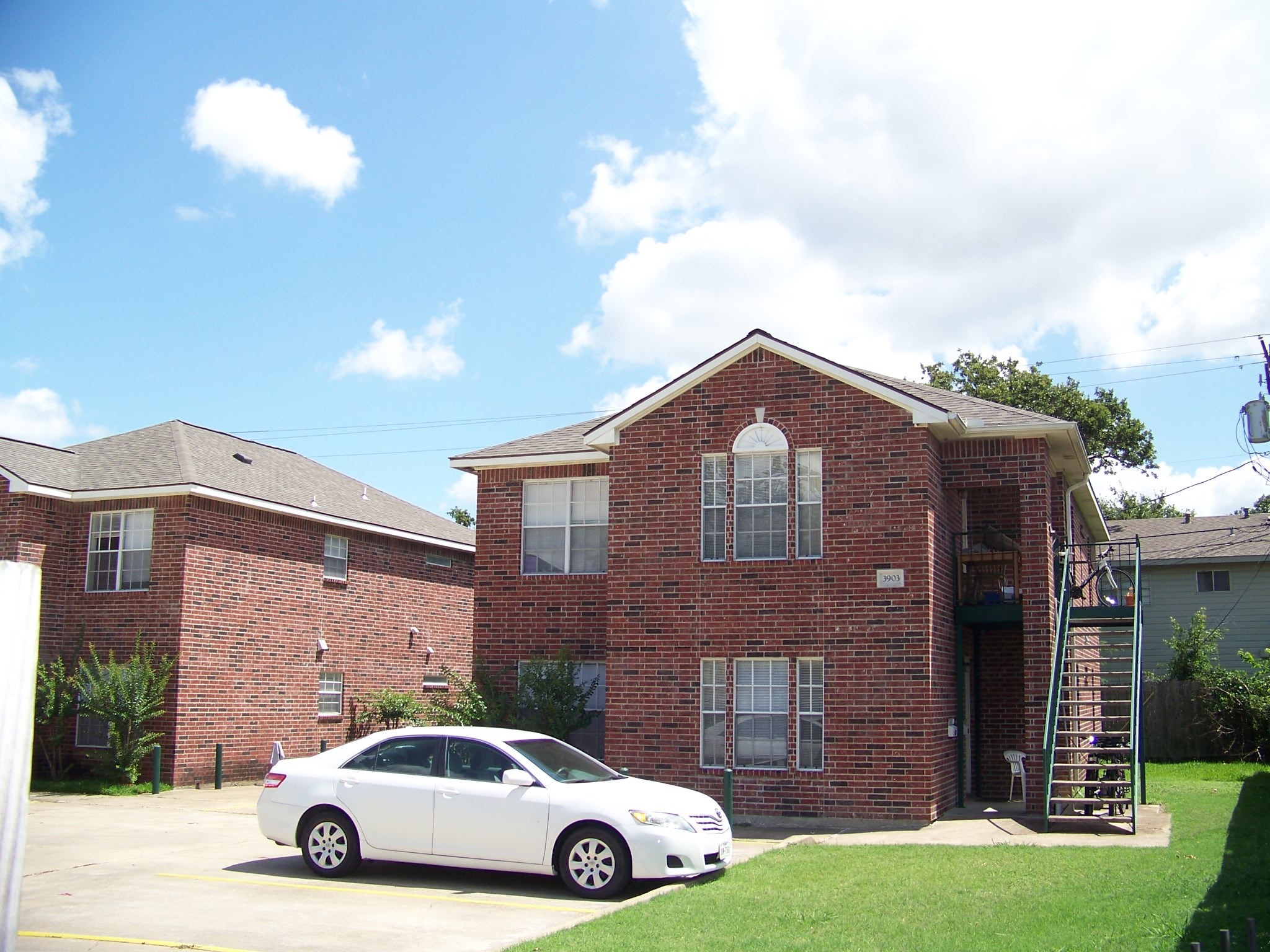 3901 College Main Street, Unit B Bryan, TX 77801 - Photo 7 of 25 a car parked in front of a brick house