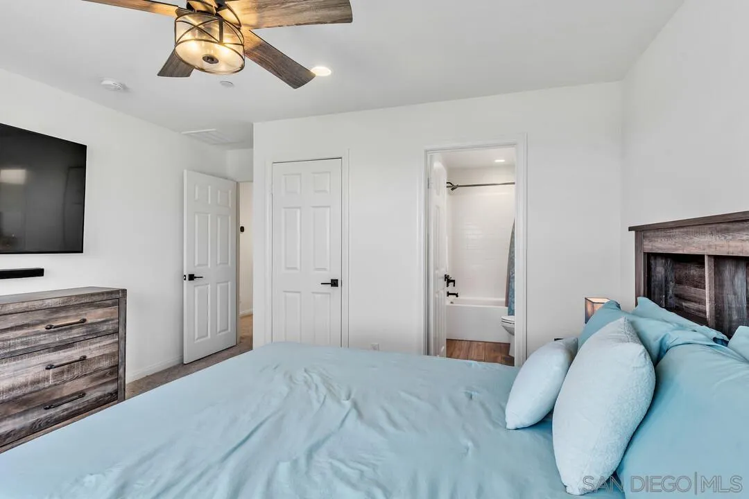2811 Safflower Street Spring Valley, CA 91977 - Photo 22 of 28 a bedroom with a bed and a flat tv screen on dresser