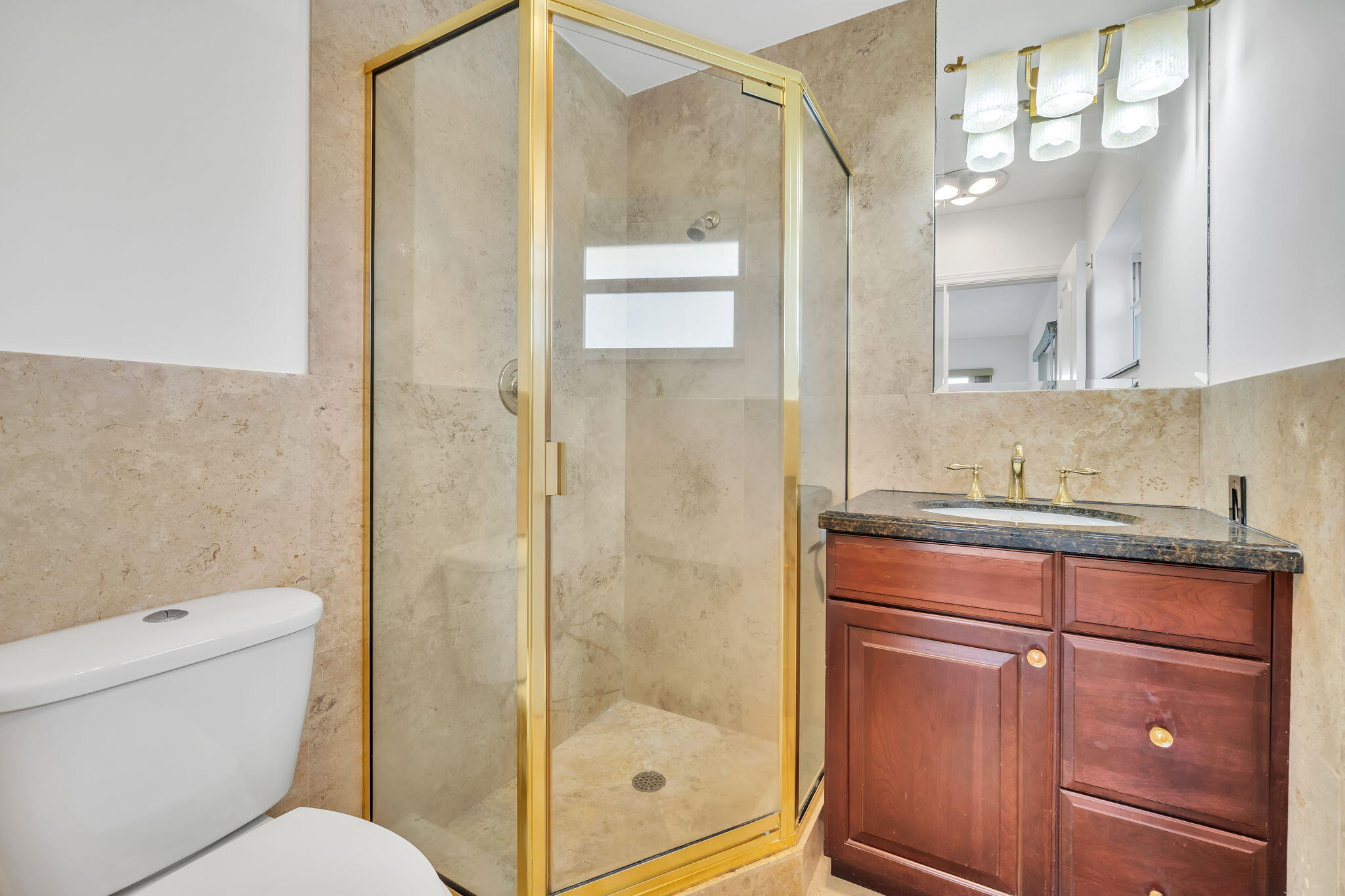 2400 Northeast 36th Street, Unit 7 Lighthouse Point, FL 33064 - Photo 19 of 27 a bathroom with a granite countertop sink toilet and shower