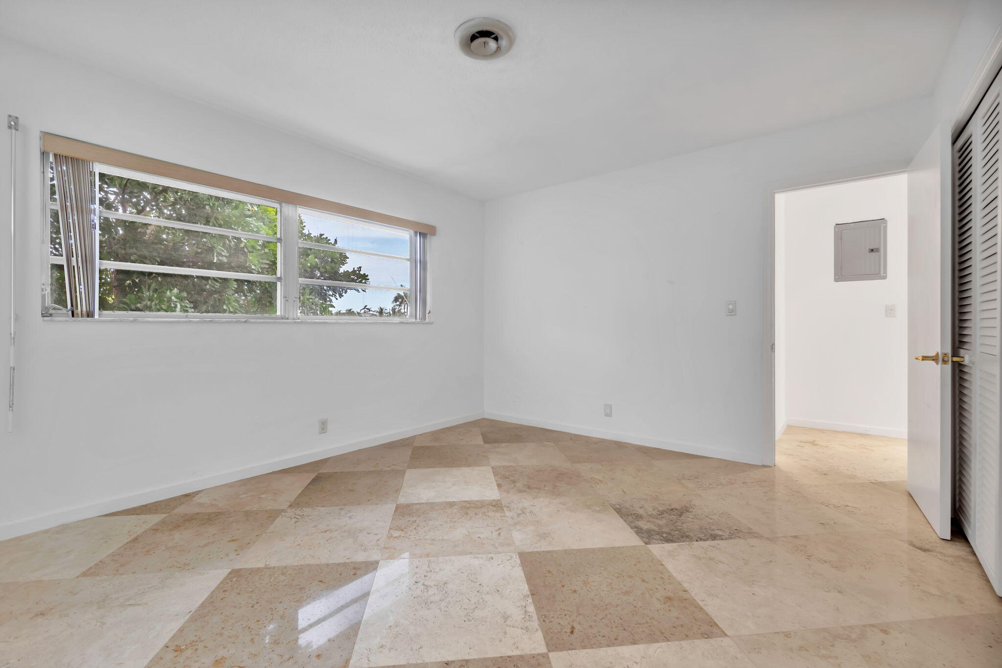 2400 Northeast 36th Street, Unit 7 Lighthouse Point, FL 33064 - Photo 23 of 27 a view of an empty room with a window