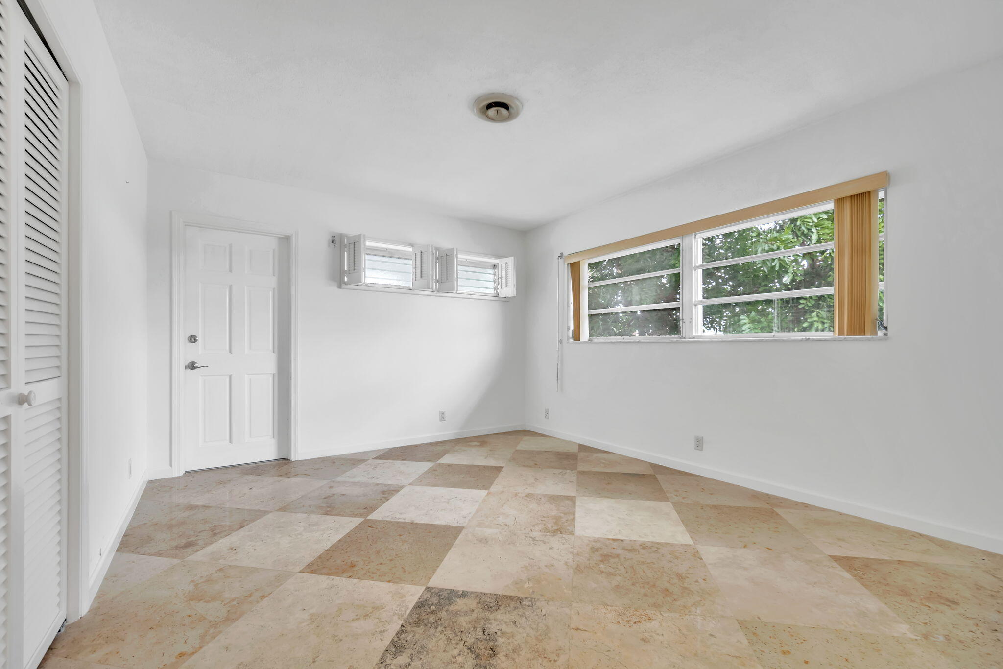 2400 Northeast 36th Street, Unit 7 Lighthouse Point, FL 33064 - Photo 24 of 27 a view of an empty room with a window