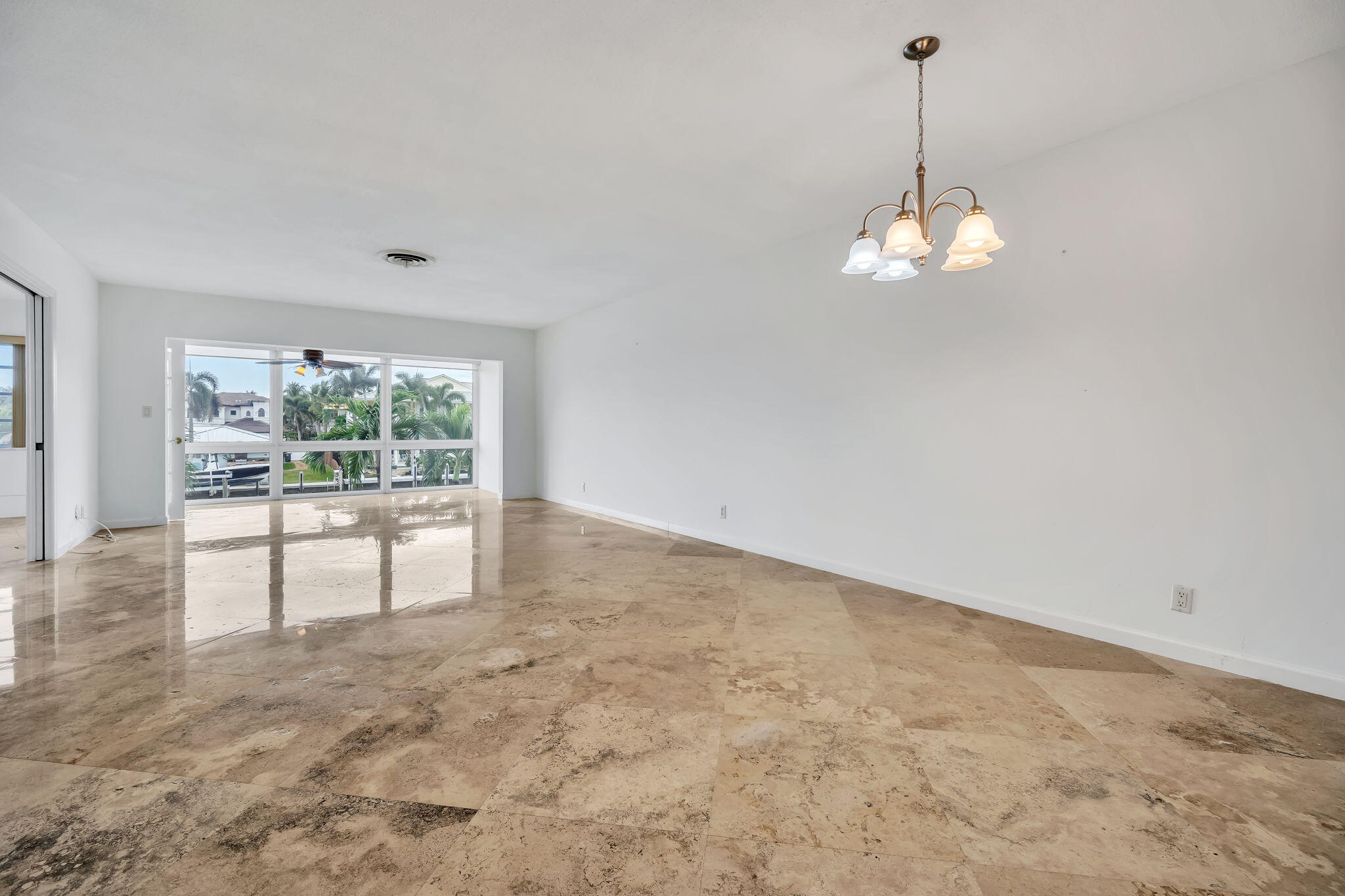 2400 Northeast 36th Street, Unit 7 Lighthouse Point, FL 33064 - Photo 3 of 27 a view of empty room with a floor to ceiling window and kitchen view