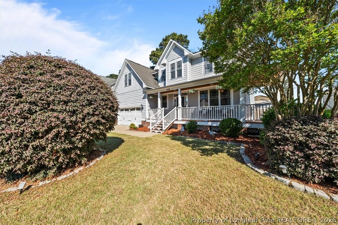 2708 Plum Ridge Road Fayetteville, NC 28306 - Photo 23 of 27 a front view of a house with a yard garage and outdoor seating