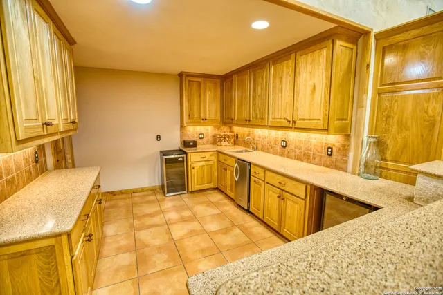a kitchen with stainless steel appliances granite countertop a sink and cabinets