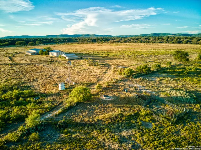 an aerial view of residential houses with outdoor space