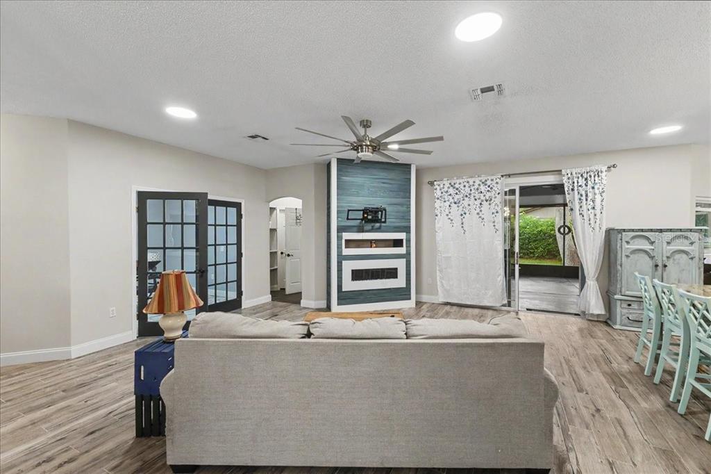 1830 Orange Tree Drive Edgewater, FL 32132 - Photo 12 of 23 a living room with furniture and a ceiling fan