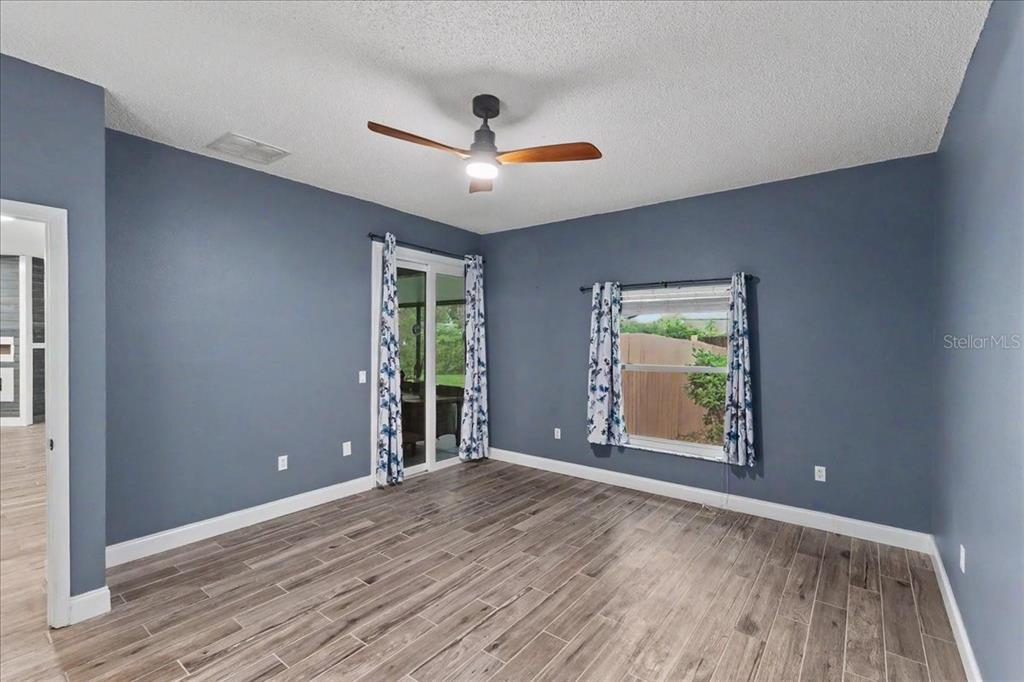 1830 Orange Tree Drive Edgewater, FL 32132 - Photo 13 of 23 wooden floor in an empty room with a window
