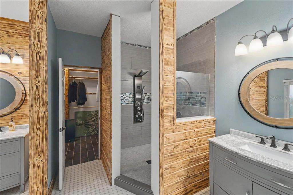 1830 Orange Tree Drive Edgewater, FL 32132 - Photo 15 of 23 a bathroom with a granite countertop sink vanity mirror and shower