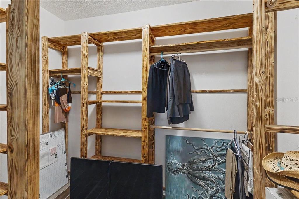 1830 Orange Tree Drive Edgewater, FL 32132 - Photo 16 of 23 a view of walk in closet with clothes and shoes