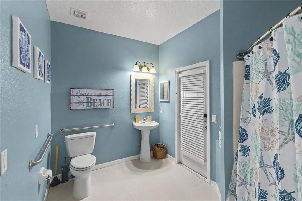 1830 Orange Tree Drive Edgewater, FL 32132 - Photo 17 of 23 a bathroom with a toilet sink and shower curtain