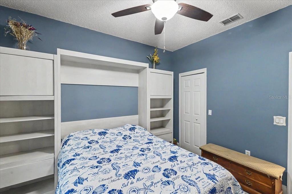 1830 Orange Tree Drive Edgewater, FL 32132 - Photo 18 of 23 a bedroom with a bed and a chandelier