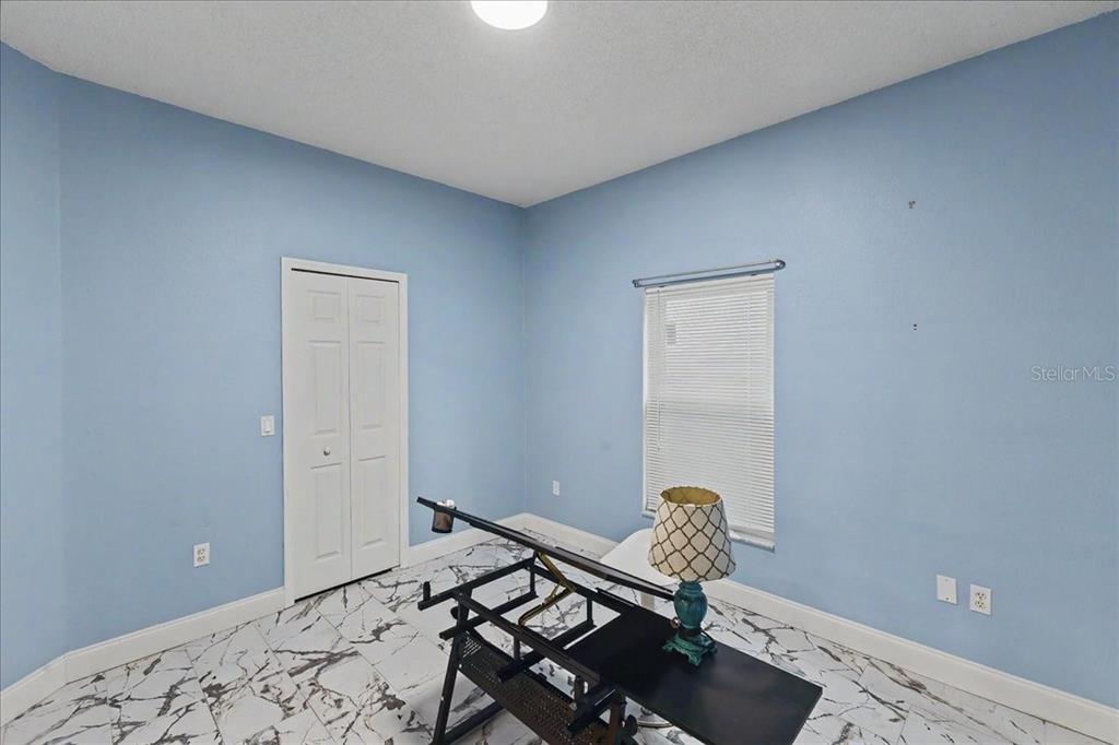 1830 Orange Tree Drive Edgewater, FL 32132 - Photo 19 of 23 a bedroom with a bed and a window