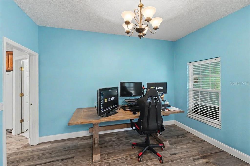 1830 Orange Tree Drive Edgewater, FL 32132 - Photo 20 of 23 a view of a workspace with furniture and a window