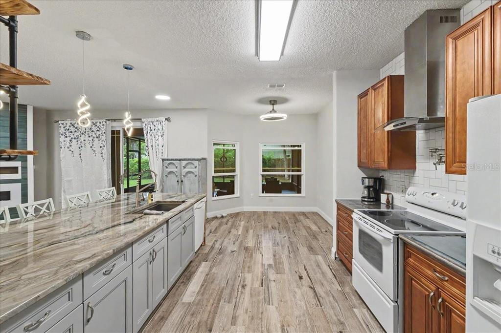 1830 Orange Tree Drive Edgewater, FL 32132 - Photo 8 of 23 a kitchen with stainless steel appliances a sink stove and cabinets