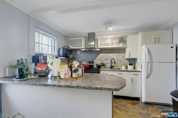 a kitchen with a sink cabinets and window