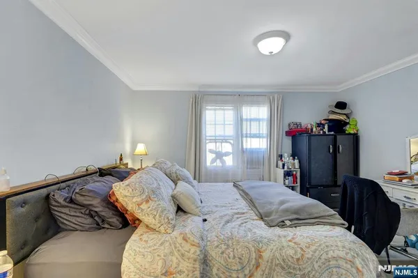 a bedroom with a bed and a lamp