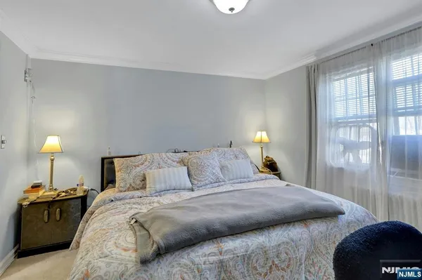 a bedroom with a bed and a lamp