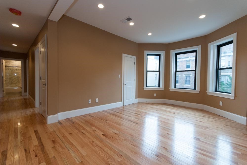 6 Lothian Road, Unit 3 Boston, MA 02135 - Photo 8 of 10 a view of empty room with wooden floor and fan