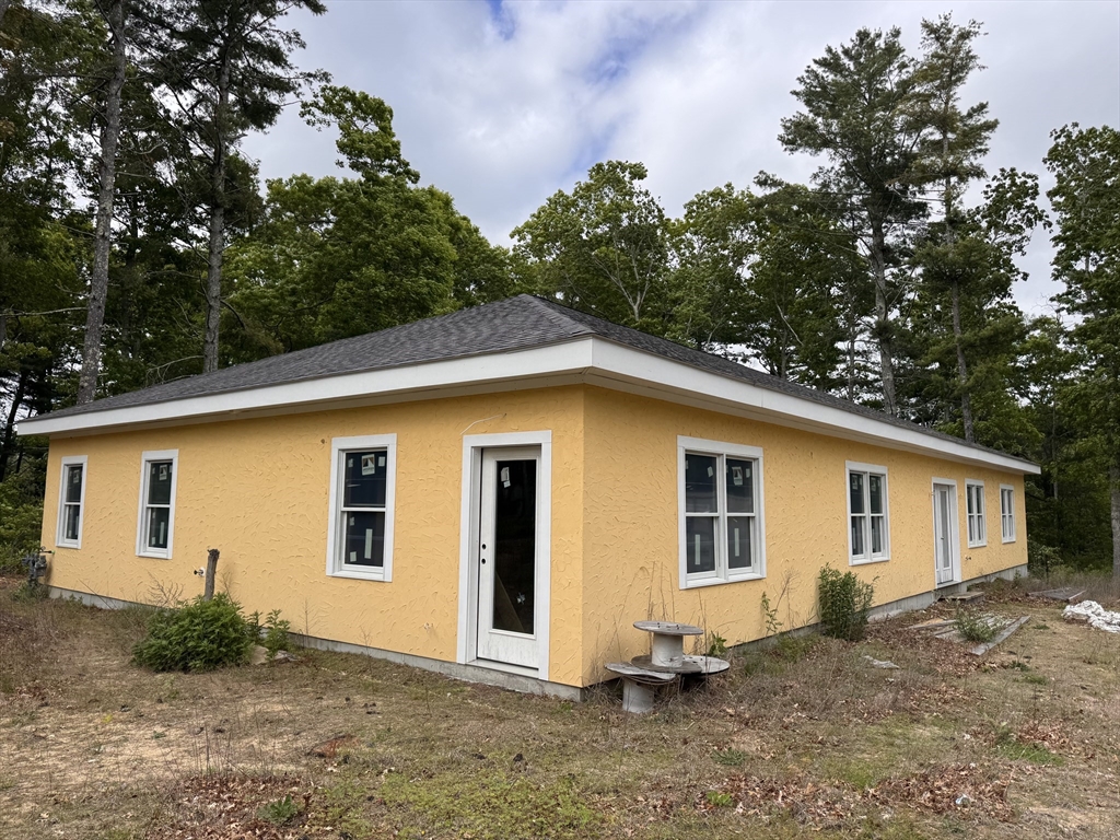a view of a house with a backyard