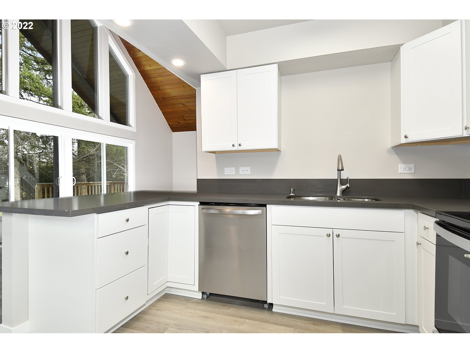 23706 Northeast 10th Avenue Ridgefield, WA 98642 - Photo 12 of 32 a kitchen with granite countertop white cabinets and white appliances
