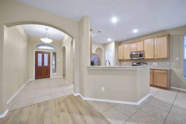 a view of a kitchen with a sink and cabinets