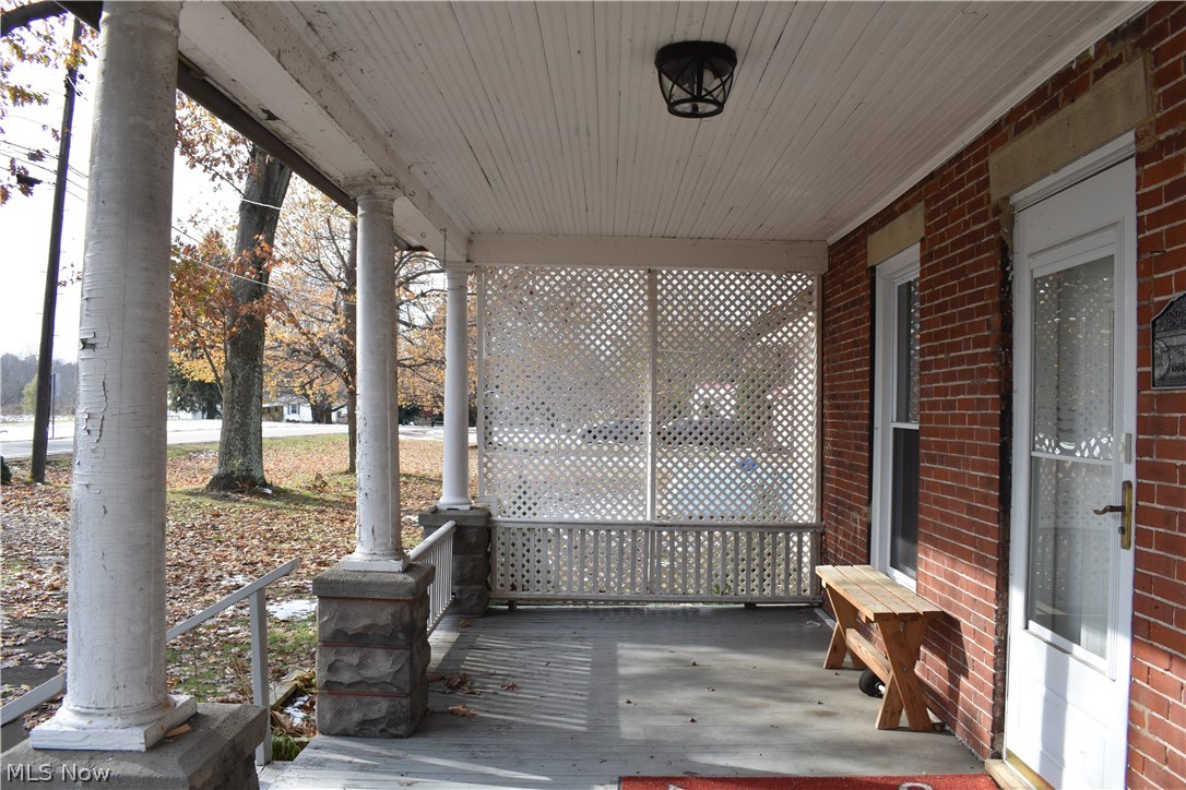 4901 South Ridge Road West Ashtabula, OH 44004 - Photo 9 of 35 Welcoming front porch to the home. Notice county historical plaque.