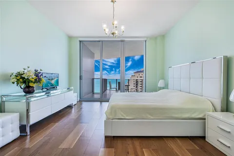 a living room with a bed mirror and couch