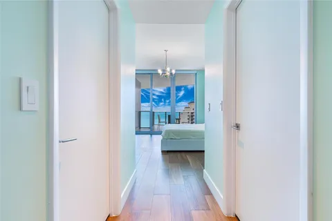 a view of a hallway view with wooden floor and staircase