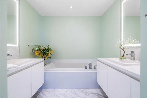 a white bath tub sitting next to a white sink