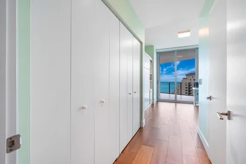 a view of a hallway with wooden floor