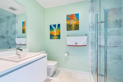 a bathroom with a sink mirror and toilet