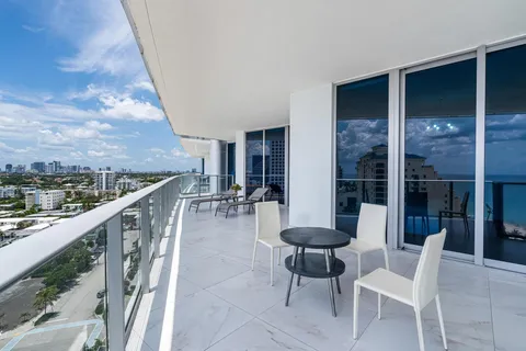 a view of a chairs and table in the balcony