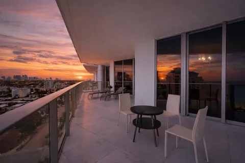 a view of a chairs and table in patio