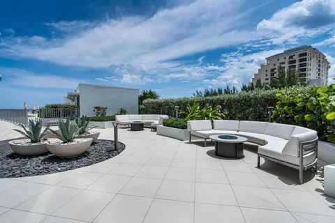 a view of a patio with couches and potted plants