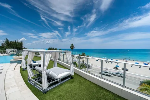 a view of a chairs and table on the roof deck