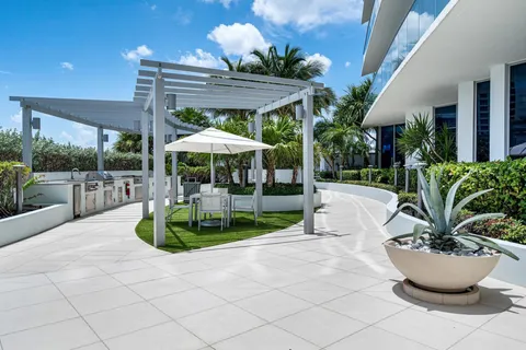 a view of a backyard with sitting area and garden
