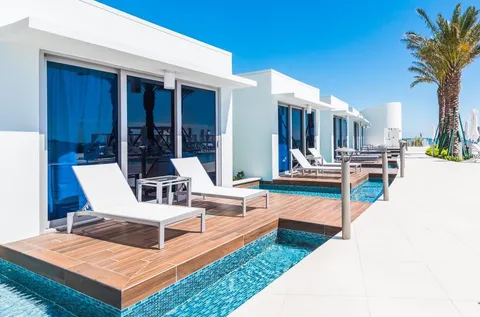 a view of a house with swimming pool and sitting area