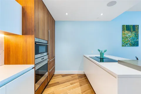 a kitchen with stainless steel appliances a sink and a refrigerator