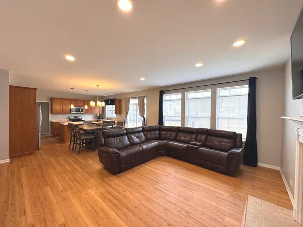 an empty room with windows and ceiling fan view