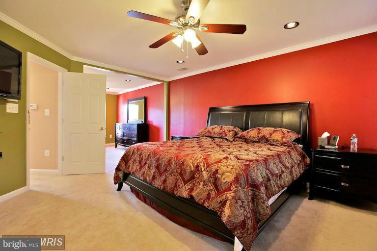 6189 Deer Ridge Trail Springfield, VA 22150 - Photo 14 of 30 a bed sitting in a spacious bedroom next to a window