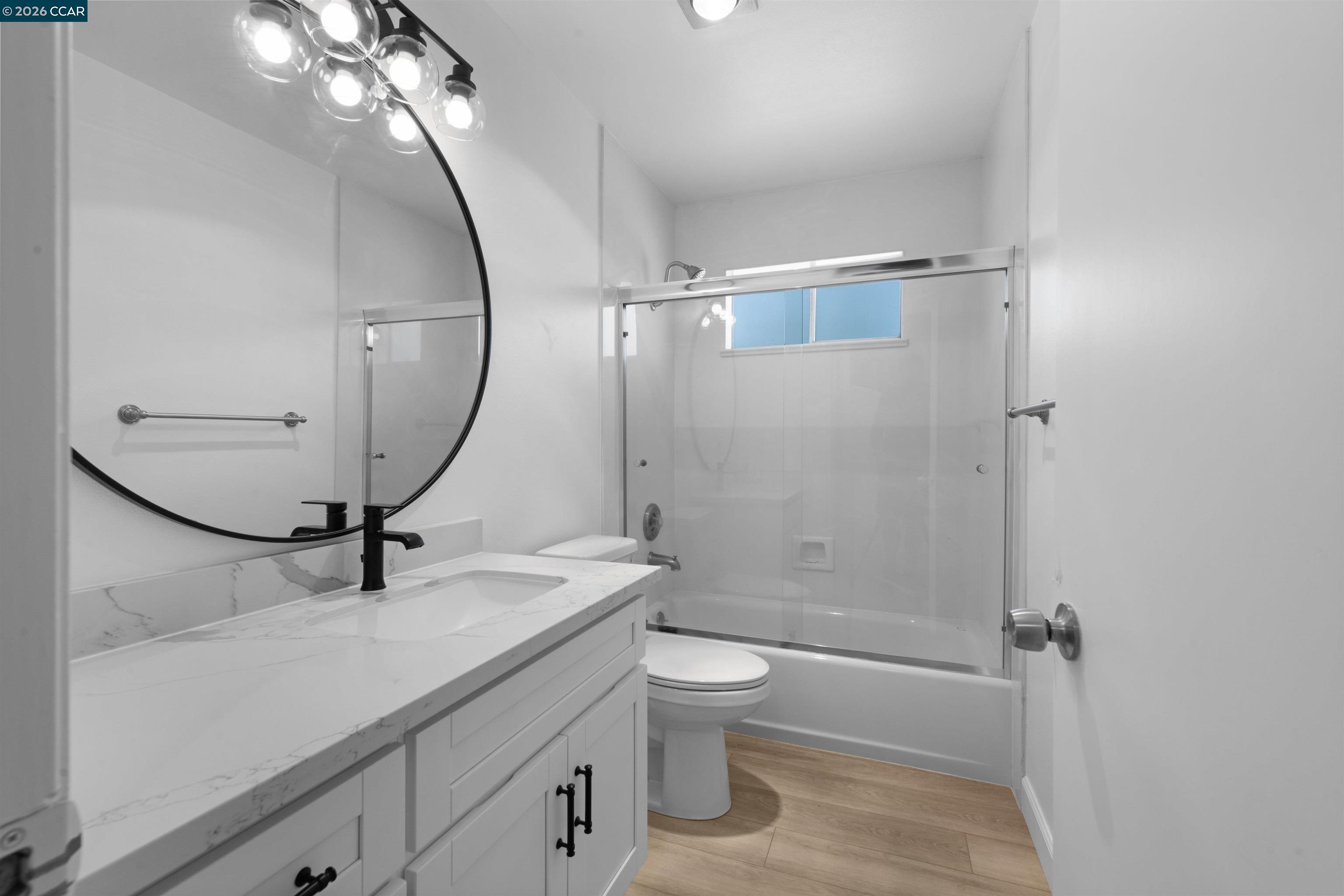 8975 Alcosta Boulevard, Unit 116 San Ramon, CA 94583 - Photo 15 of 30 a bathroom with a sink a toilet a mirror and shower