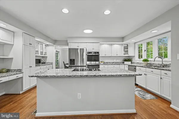a kitchen with granite countertop a sink and cabinets