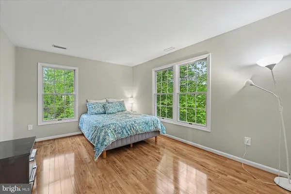 a living room with a bed and a large window