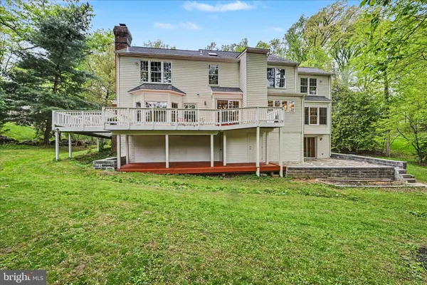 a view of a house with a yard and sitting area