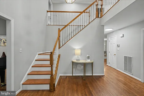 a view of entryway and hall with wooden floor