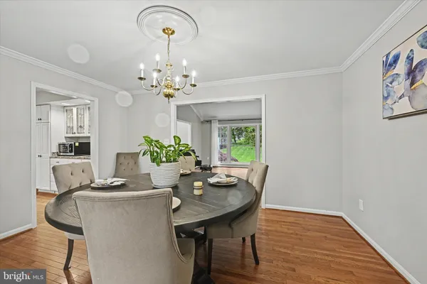 a view of a dining room with furniture and chandelier
