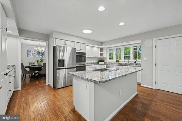 a kitchen with refrigerator and cabinets